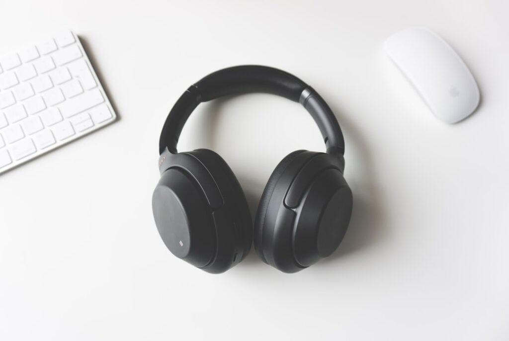 Wireless headphones beside a computer for Bluetooth troubleshooting