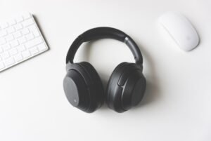 Wireless headphones beside a computer for Bluetooth troubleshooting