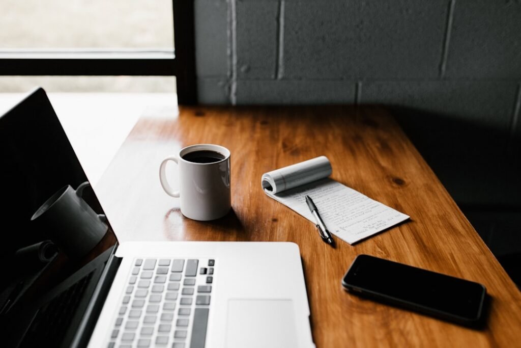 Laptop and notebook on a desk for scheduling an email in Gmail