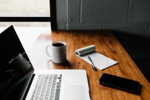 Laptop and notebook on a desk for scheduling an email in Gmail