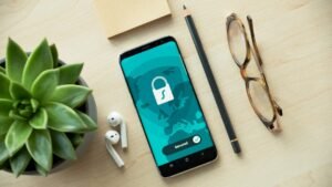 Smartphone beside a padlock representing WhatsApp privacy settings