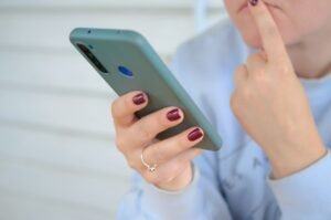 Person holding a smartphone while reviewing an unknown call
