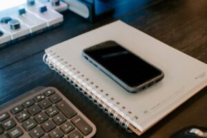 Smartphone resting on a notebook ready to scan a document